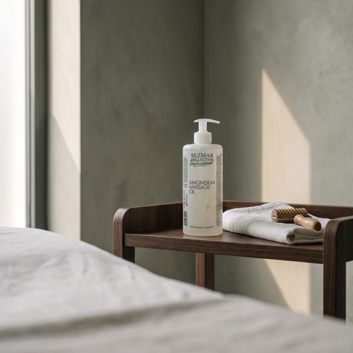 Sezmar Collection Professional Magnesium Massage Oil 500 ml on a wooden trolley in a treatment room