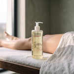 Anti Cellulite & Anti Stretch Oil with Pineapple 500 ml on a massage couch